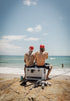 Two men fishing from a beach with a Dometic Cool-Ice icebox