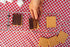 Three s'mores in a Coghlan's grill on a picnic table