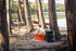 Coghlan's mini pop-up trash can beside a camp table at a lakeside site