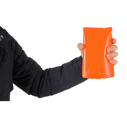 Hand holding the packed Lifesystems Survival Bag to show its size