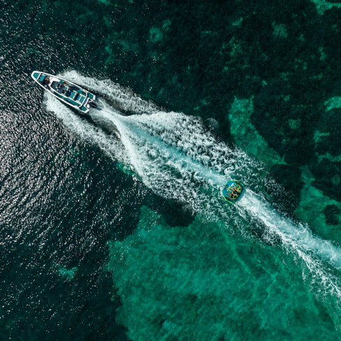 Aerial view of a boat towing the Jobe Binar Towable 3P, lifestyle