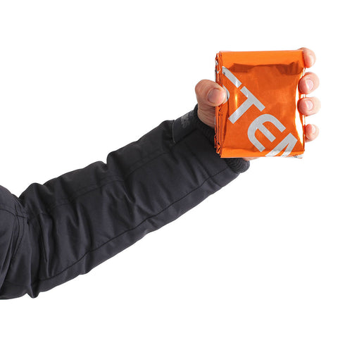 Hand holding the packed Lifesystems Thermal Bag to show its size