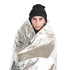 Person wrapped in a Coghlan's emergency blanket, front view