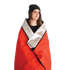 Person wrapped in a Coghlan's red and silver thermal blanket