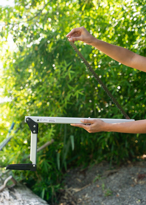 Camper cutting a branch with a Coghlan's folding saw
