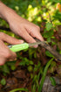 Camper using a Coghlan's 11 function camp knife outdoors