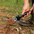 Camper digging with a Coghlan's mini shovel with pick
