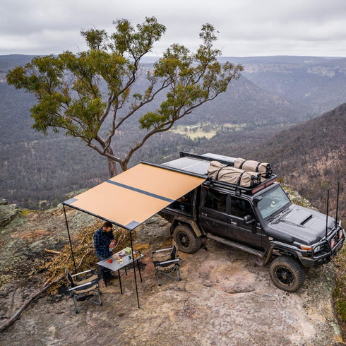 ARB Canopy Awning, 2.5m x 2.5m black aluminum housing retractable vehicle shelter with integrated LED lighting.