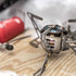 Primus OmniFuel stove burning on a rock outdoors, lifestyle