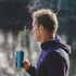 Man holding a Gloss Blue Lifeventure Thermal Mug outdoors