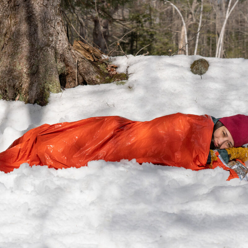 0140-1142-Emergency-Bivvy-Orange-w-whistle-2-laying_down__63738.1693582250